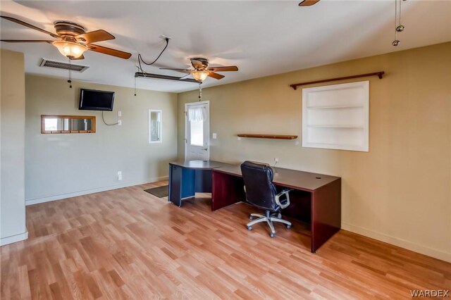 office space with attic access, baseboards, visible vents, and light wood finished floors