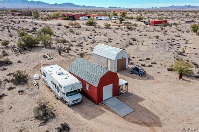 birds eye view of property featuring a mountain view and a desert view