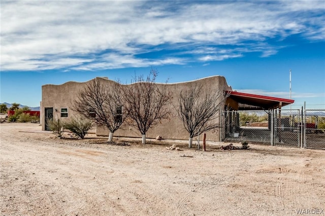 exterior space with fence and stucco siding