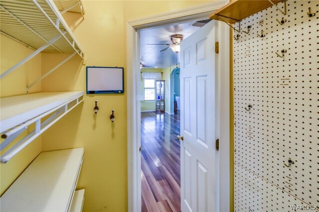 interior space with a ceiling fan and wood finished floors