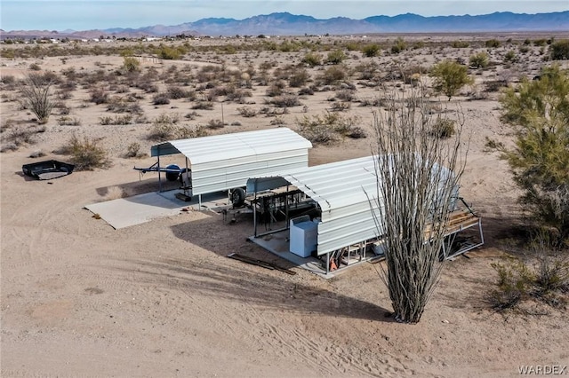 aerial view featuring a desert view and a mountain view