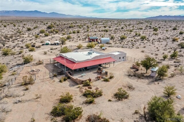 aerial view featuring a mountain view and a desert view