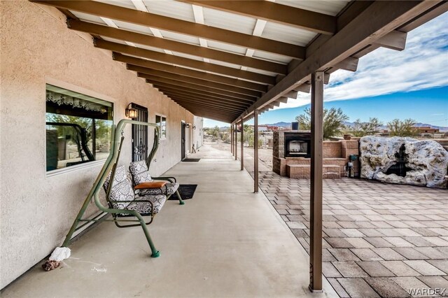 view of patio featuring exterior fireplace