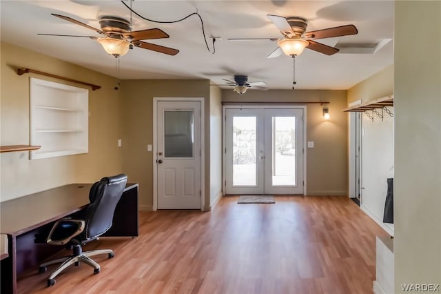 unfurnished office with light wood-style flooring, baseboards, ceiling fan, and french doors