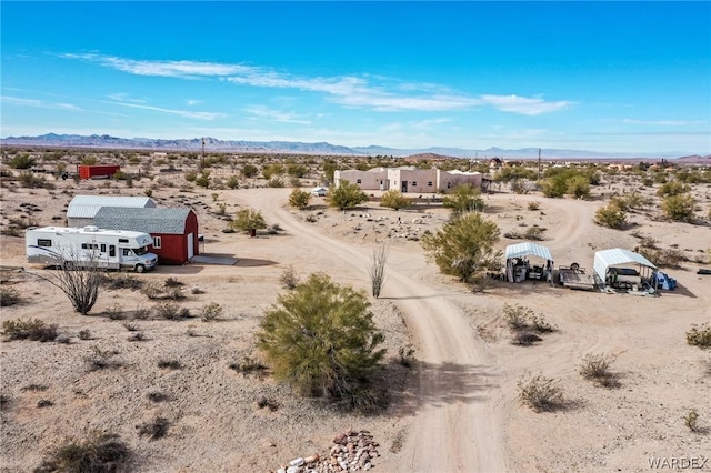 birds eye view of property with a mountain view and view of desert