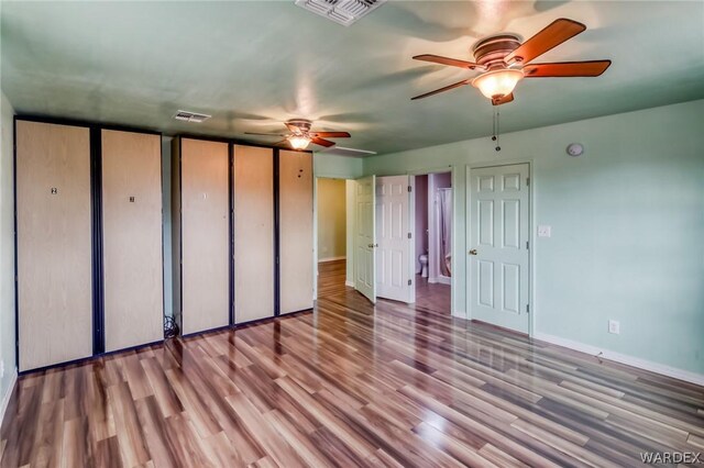 unfurnished bedroom with ceiling fan, light wood finished floors, visible vents, and baseboards