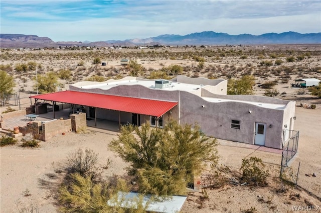 birds eye view of property with a desert view and a mountain view