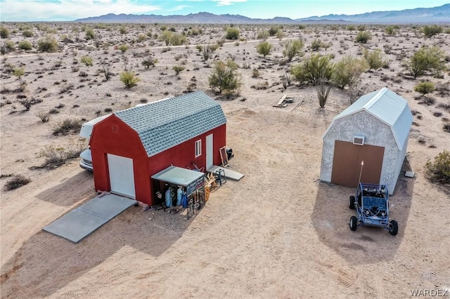 birds eye view of property with a desert view and a mountain view