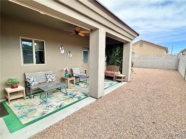 view of patio with outdoor lounge area, a fenced backyard, and a ceiling fan