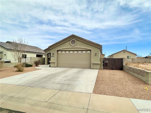 view of front of home featuring a garage, fence, concrete driveway, and stucco siding