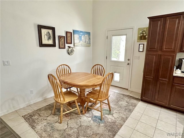 dining area with light tile patterned floors and baseboards