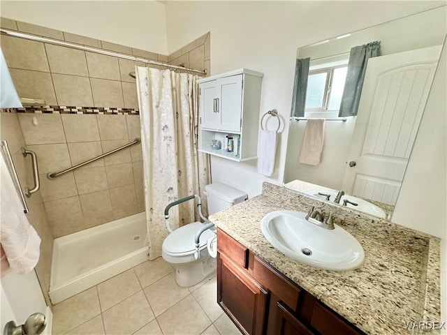 full bath with a stall shower, tile patterned flooring, vanity, and toilet