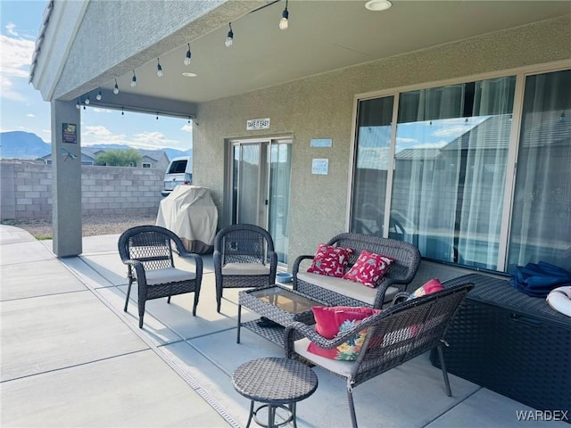 view of patio / terrace featuring fence and outdoor lounge area