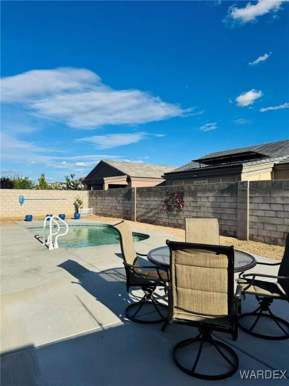 view of patio / terrace with a fenced in pool, outdoor dining area, and a fenced backyard