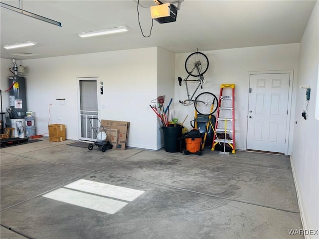 garage with baseboards, a garage door opener, and water heater