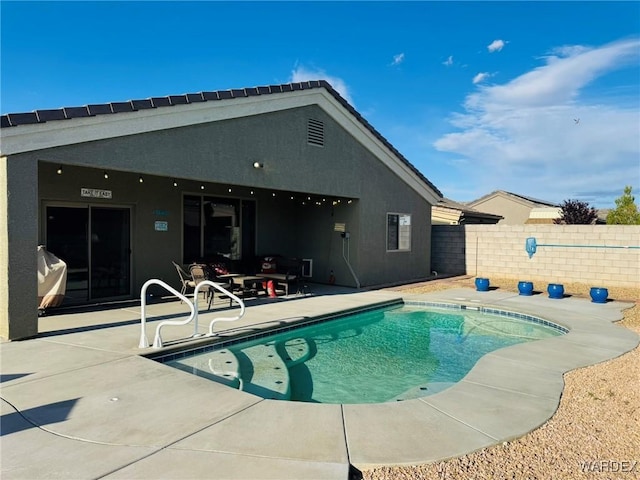 view of swimming pool with a patio, fence, and a fenced in pool
