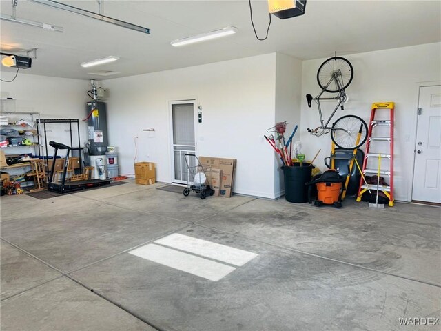 garage with water heater and a garage door opener