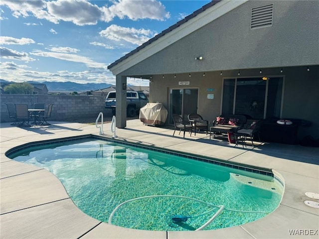 view of swimming pool featuring fence, a fenced in pool, and a patio area