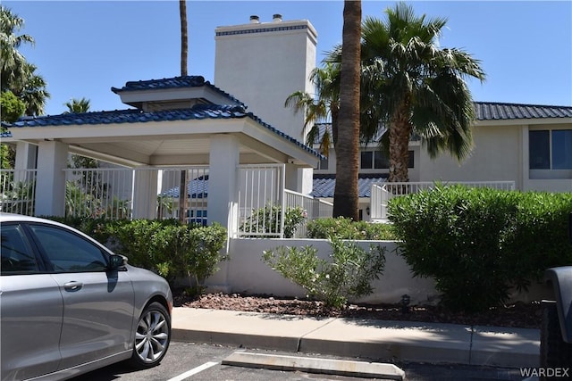 view of property featuring uncovered parking and fence