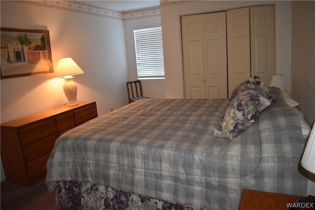 bedroom with crown molding and a closet