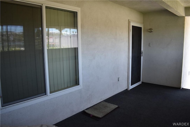 doorway to property with stucco siding