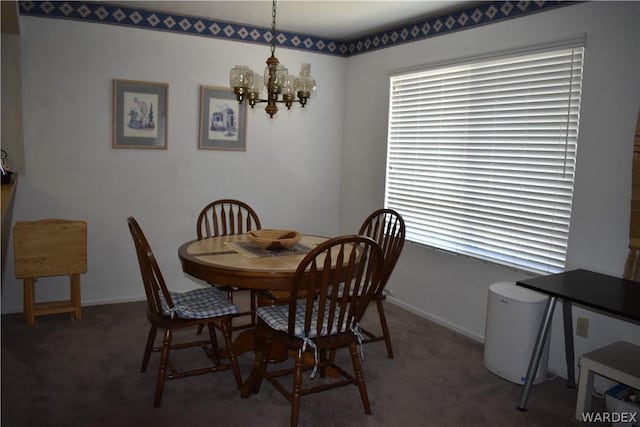 1800 Clubhouse Dr Unit 100, Bullhead City, AZ 86442 - dining room with baseboards, dark colored carpet, and a notable chandelier