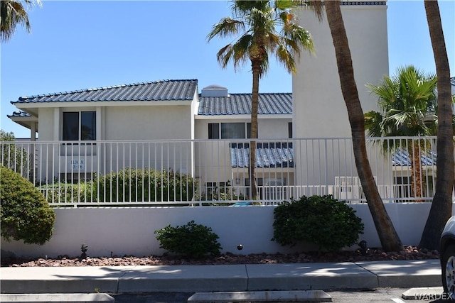 view of front of house featuring a fenced front yard and stucco siding