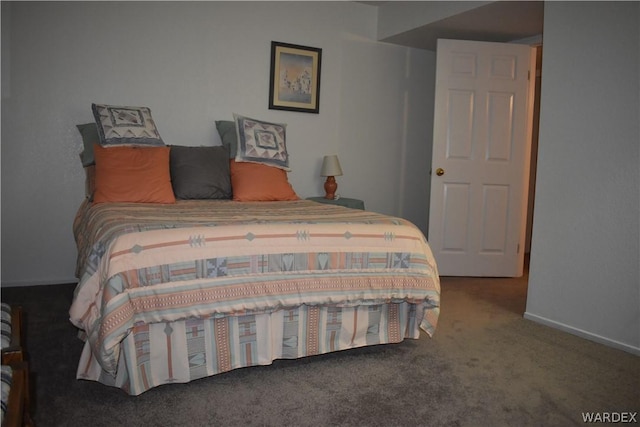 carpeted bedroom featuring baseboards