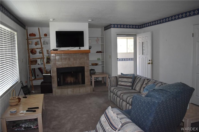 carpeted living room with a fireplace