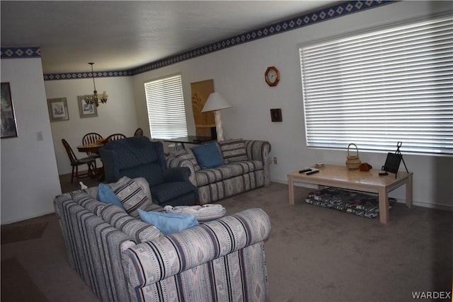 living room featuring a chandelier and carpet