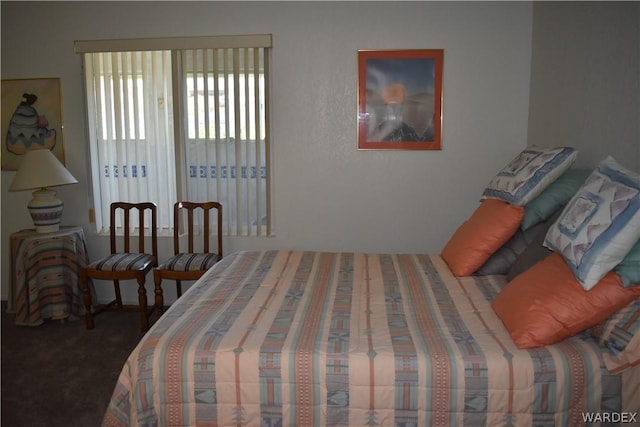 bedroom featuring dark carpet