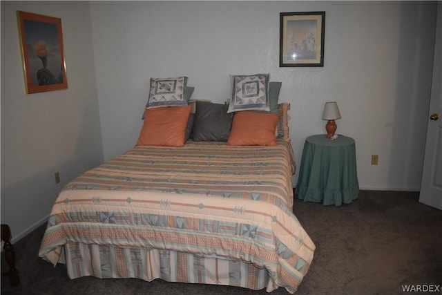 bedroom with dark colored carpet