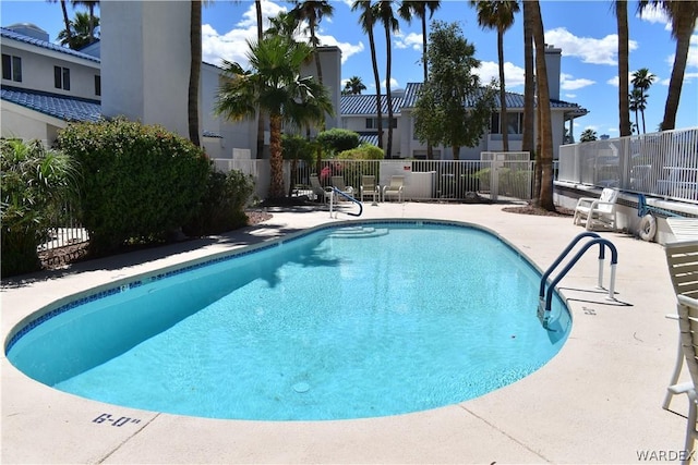 pool featuring a patio area and fence