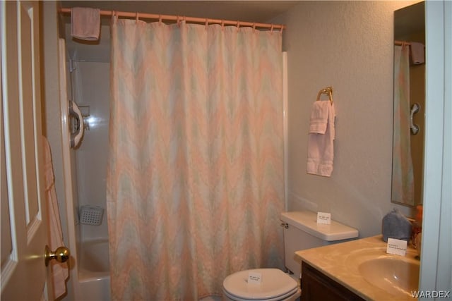 bathroom with shower / bath combo, vanity, and toilet