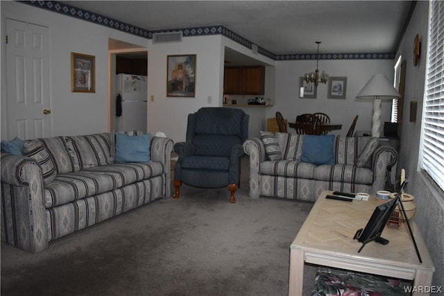 1800 Clubhouse Dr Unit 100, Bullhead City, AZ 86442 - carpeted living area featuring visible vents and a notable chandelier