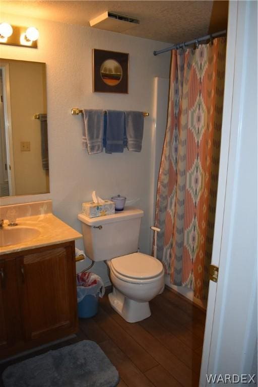 bathroom with a shower with curtain, vanity, toilet, and wood finished floors