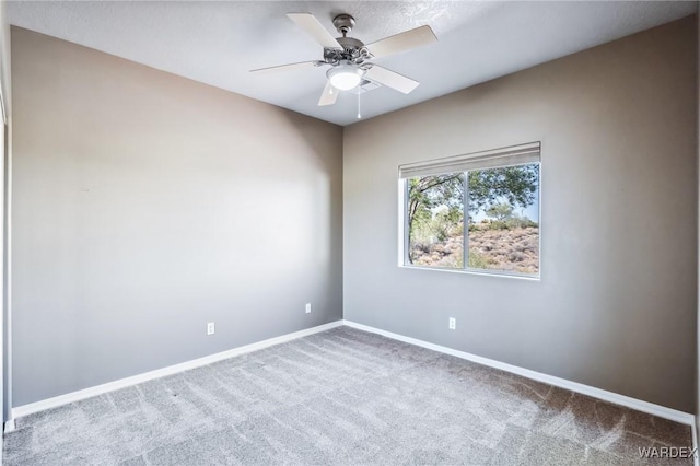 carpeted spare room with baseboards and ceiling fan