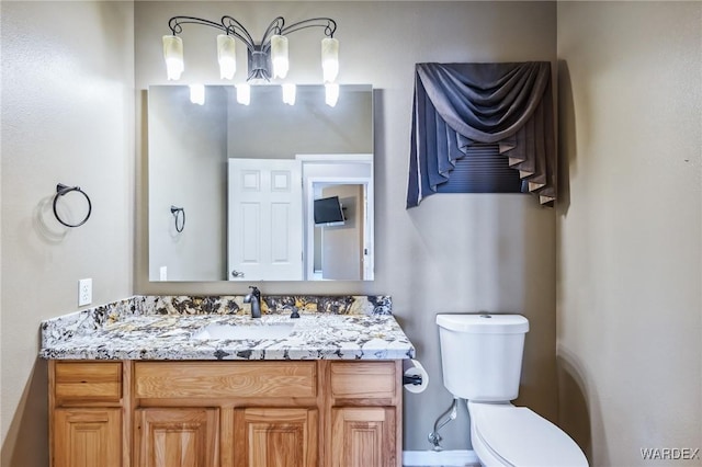 bathroom featuring toilet and vanity