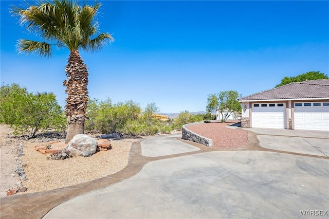 view of yard with driveway and a garage