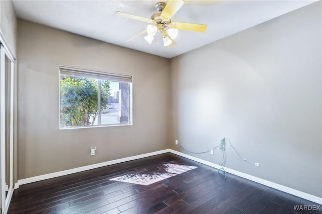 spare room featuring baseboards, ceiling fan, and wood finished floors