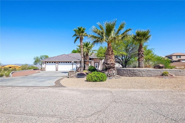 single story home featuring concrete driveway and an attached garage