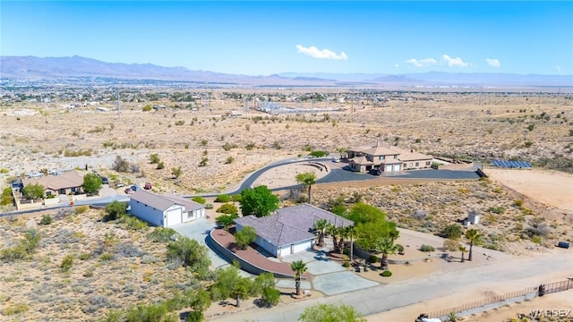 bird's eye view featuring a mountain view, a desert view, and a rural view