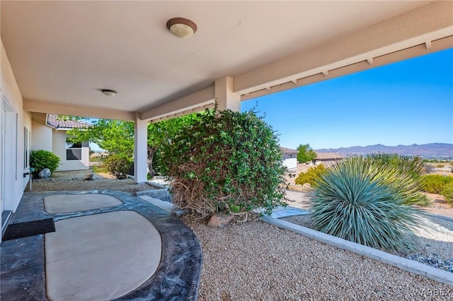 view of yard featuring a patio area and a mountain view