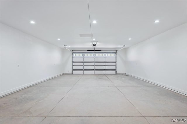 garage with recessed lighting, baseboards, and a garage door opener