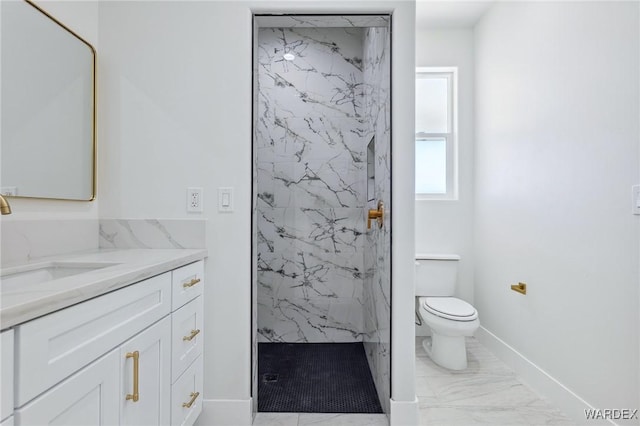 bathroom featuring a marble finish shower, baseboards, toilet, marble finish floor, and vanity