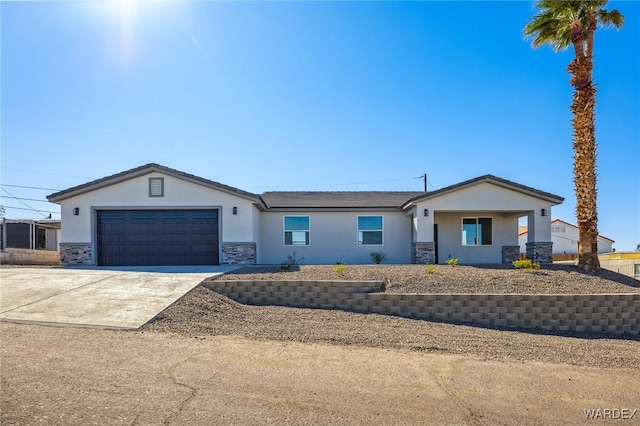 single story home with a garage, stone siding, driveway, and stucco siding