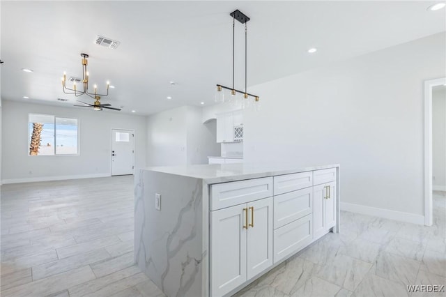 kitchen with baseboards, visible vents, white cabinets, and recessed lighting