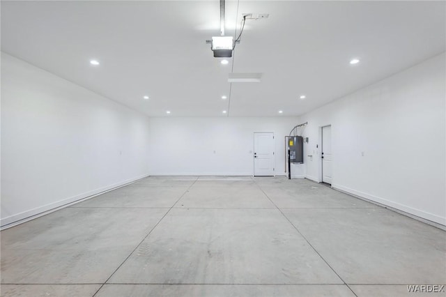 garage with water heater, a garage door opener, baseboards, and recessed lighting