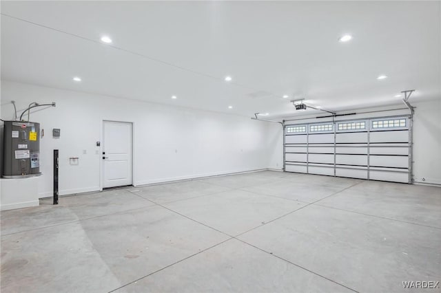 garage featuring recessed lighting, baseboards, a garage door opener, and electric water heater