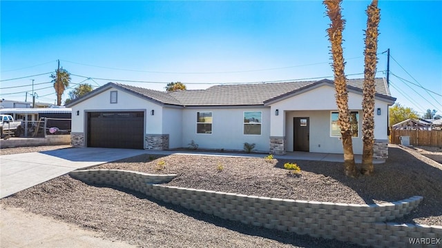 single story home featuring stone siding, concrete driveway, fence, and a garage